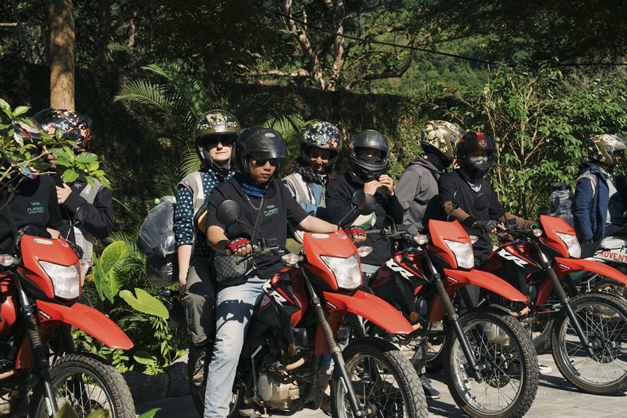 Guides lined up on their enduro bikes on a jungle track