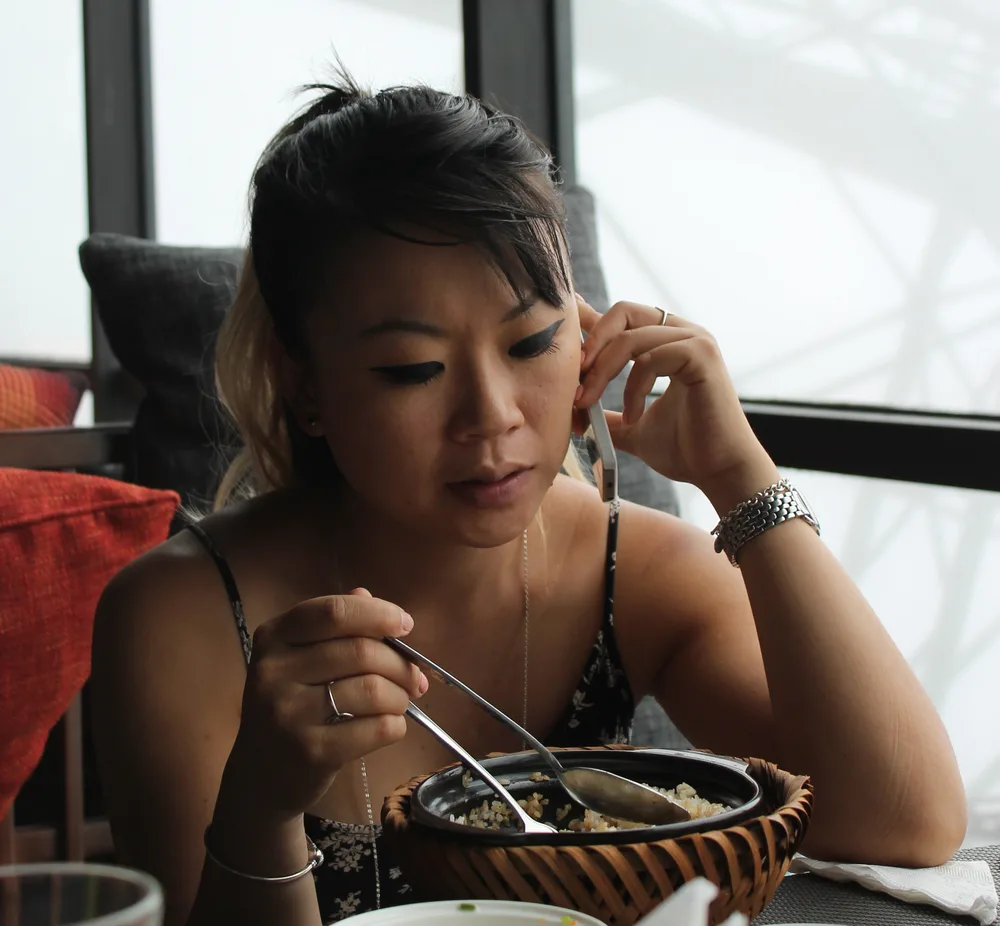 Linh on the phone, sorting something out