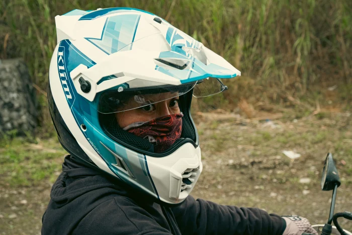 Linh in a riding helmet, sitting on a bike