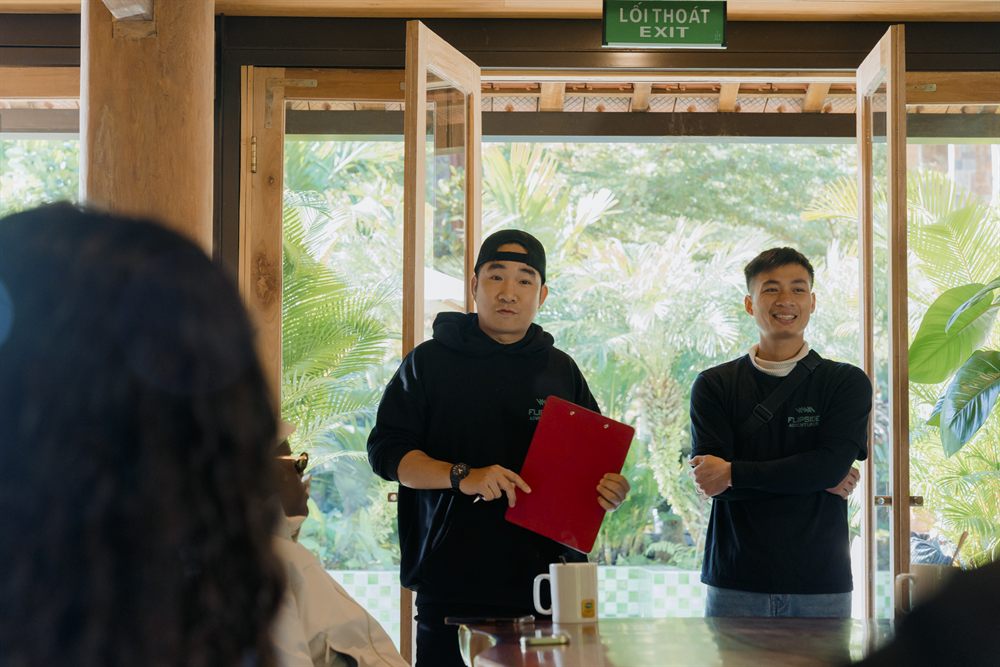 Two guides running the pre-ride safety briefing, one holding a clipboard