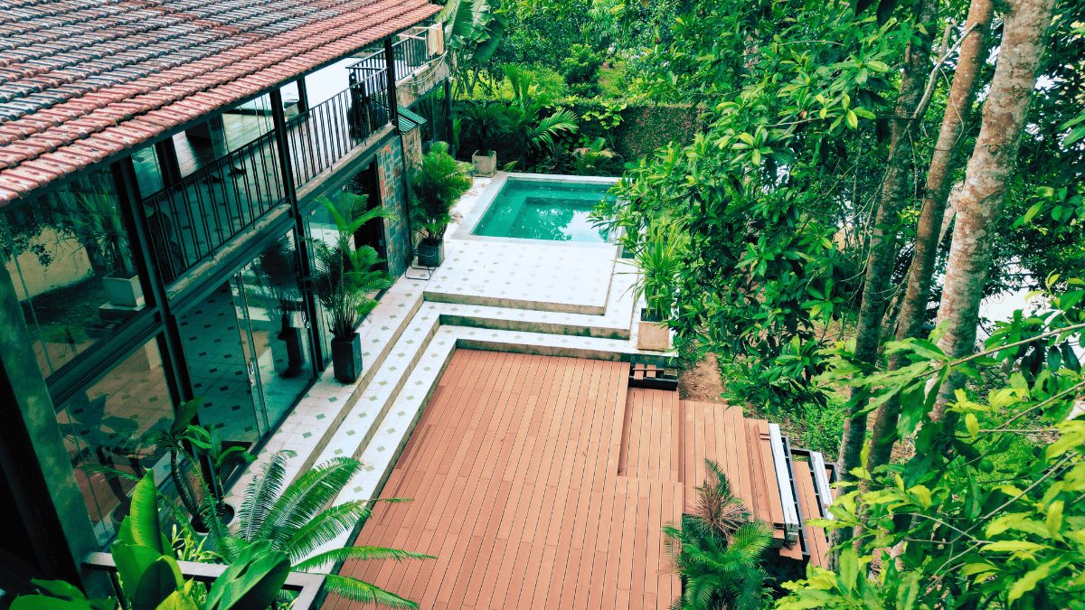 The timber deck and pool seen from above through the trees