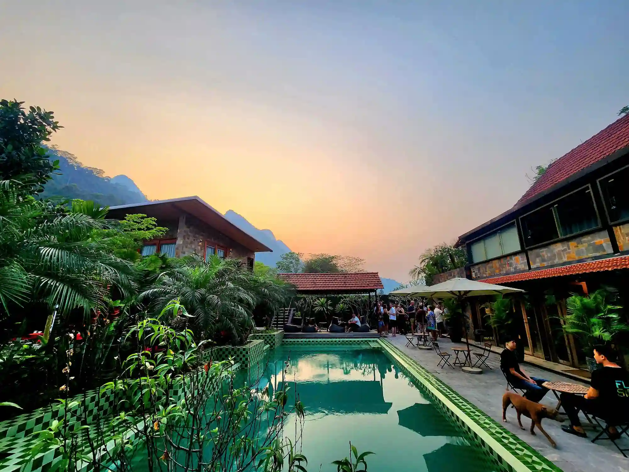 The pool at sunset, with the villa buildings and mountains behind