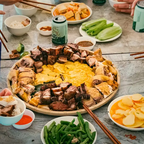 A shared platter of roast meats, egg and vegetables at a homestay dinner