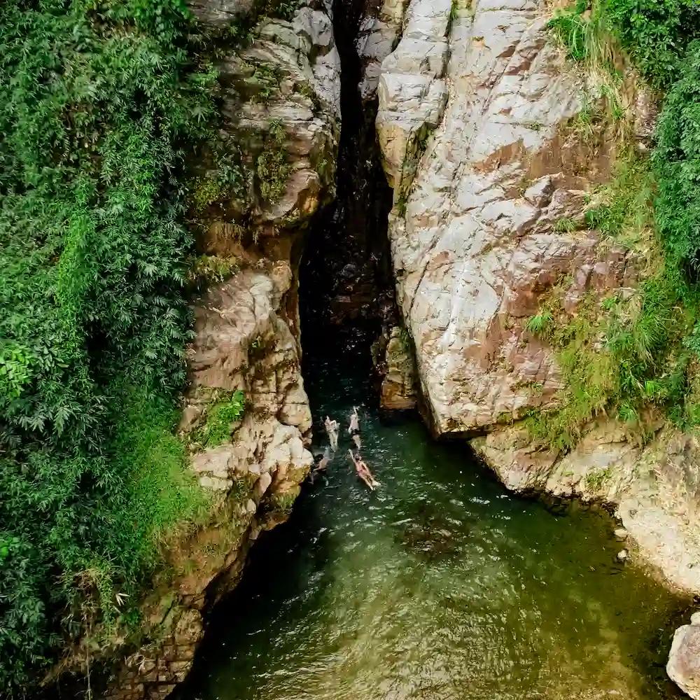Kayaks on green water between the walls of a gorge